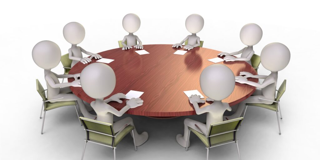Eight People Sitting on a Round Table
